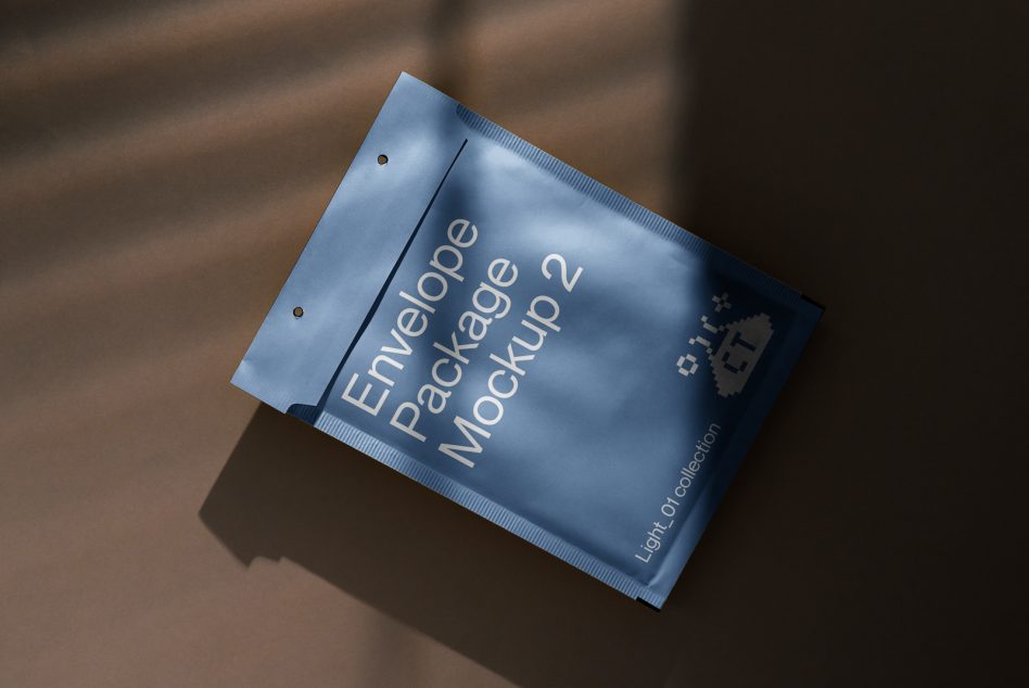 Soft blue envelope mockup with hole punches casting shadows on brown background